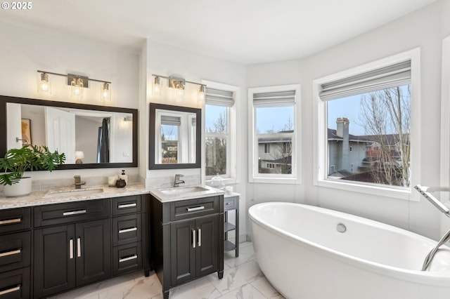 bathroom featuring a washtub and vanity