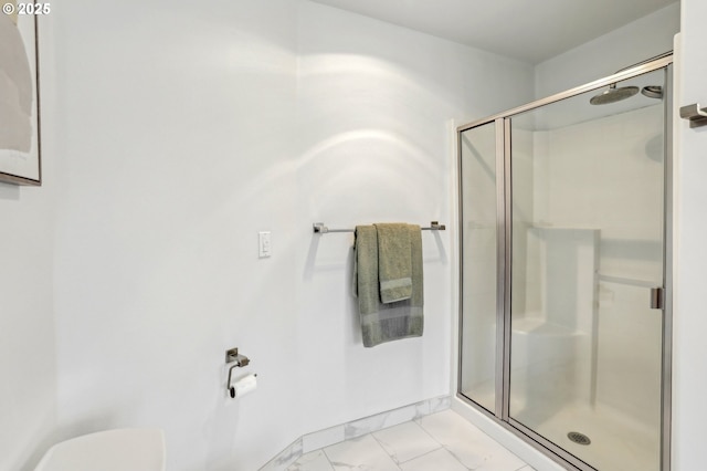 bathroom with a shower with door