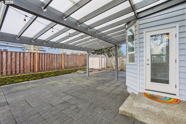 view of patio with a storage shed and a pergola