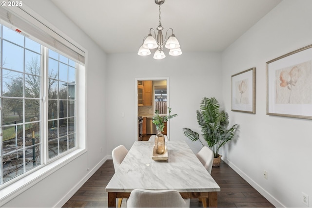 dining room featuring dark hardwood / wood-style flooring and a chandelier