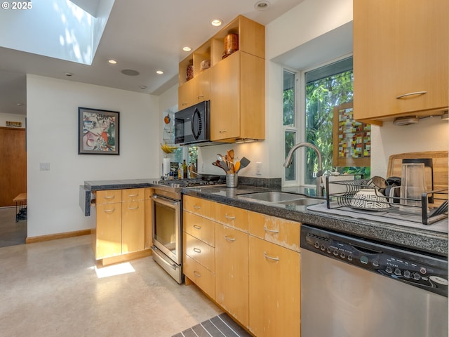 6310 NE 31st Ave Unit A, And B, Portland, OR 97211 - kitchen with appliances with stainless steel finishes, a sink, a peninsula, dark stone countertops, and recessed lighting