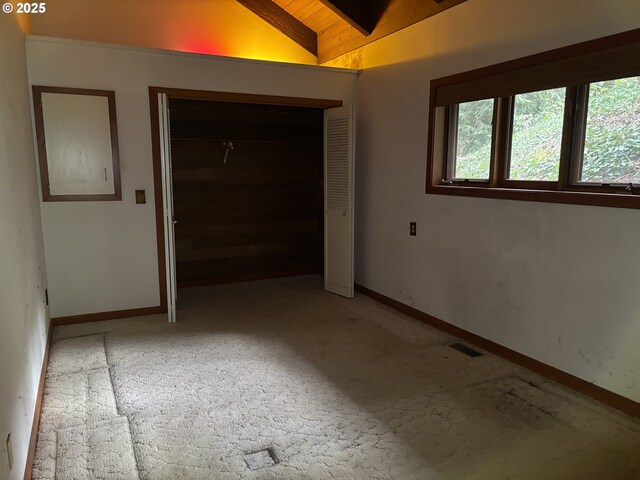 interior space with vaulted ceiling, carpet, and wooden ceiling