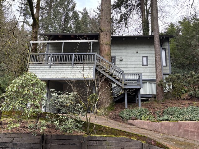 rear view of house featuring a wooden deck