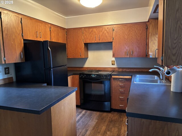 kitchen with sink, dark wood-type flooring, and black appliances