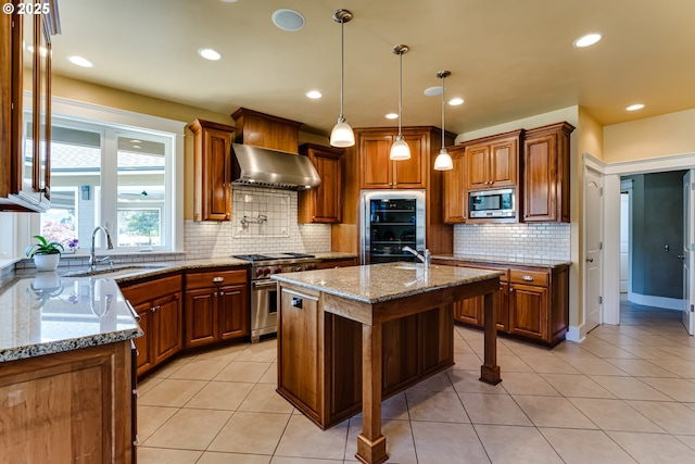 83500 Enterprise Rd, Creswell, OR 97426 - kitchen featuring stainless steel appliances, wall chimney range hood, brown cabinetry, backsplash, and recessed lighting