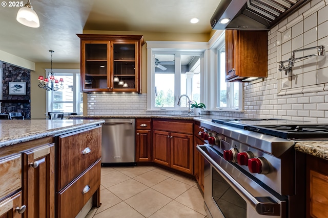 83500 Enterprise Rd, Creswell, OR 97426 - kitchen featuring appliances with stainless steel finishes, wall chimney exhaust hood, tasteful backsplash, and healthy amount of natural light