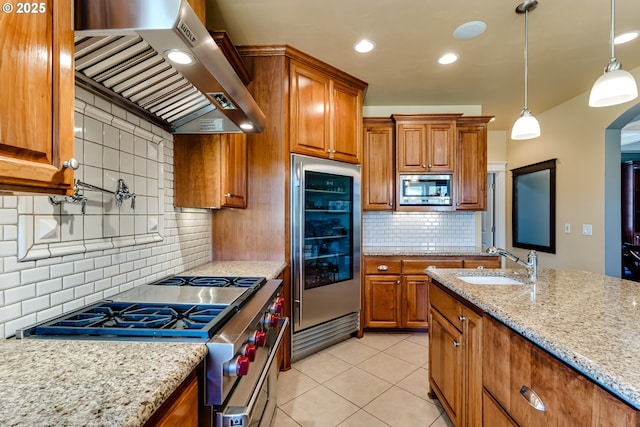 83500 Enterprise Rd, Creswell, OR 97426 - kitchen with stainless steel appliances, custom range hood, brown cabinets, decorative backsplash, and light stone counters