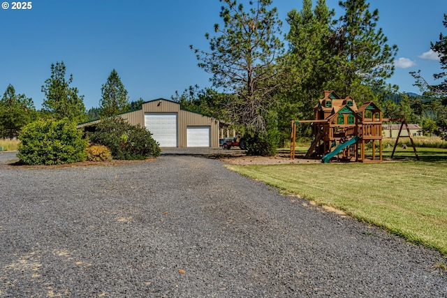 83500 Enterprise Rd, Creswell, OR 97426 - view of front of home featuring a playground, a garage, a front yard, and an outdoor structure