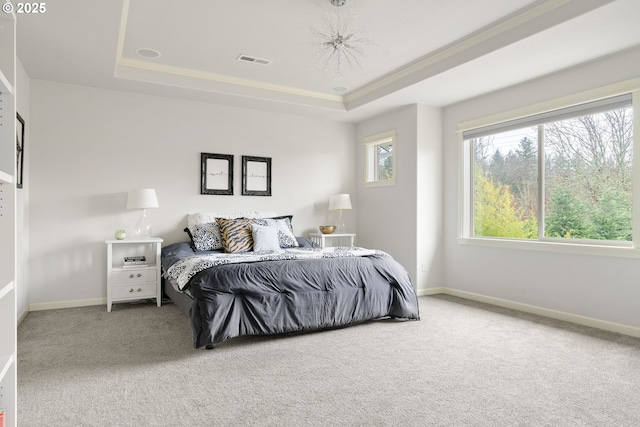 carpeted bedroom featuring a raised ceiling, visible vents, and baseboards