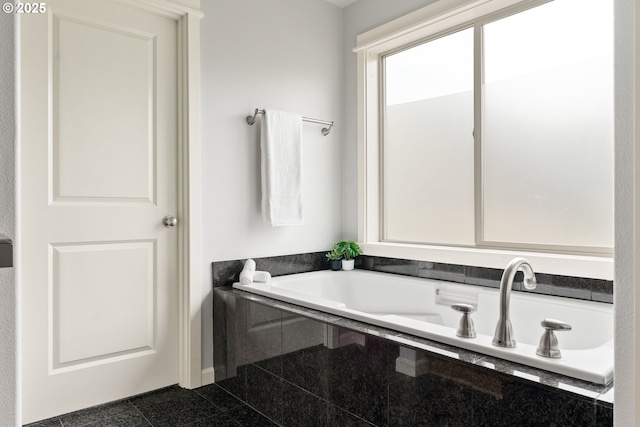 full bath with granite finish floor and a washtub