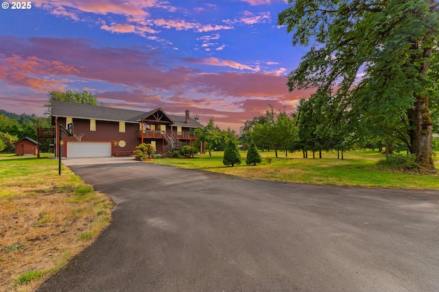 4311 NW 419th St, Woodland, WA 98674 - view of front of property with stairway, asphalt driveway, and a front lawn