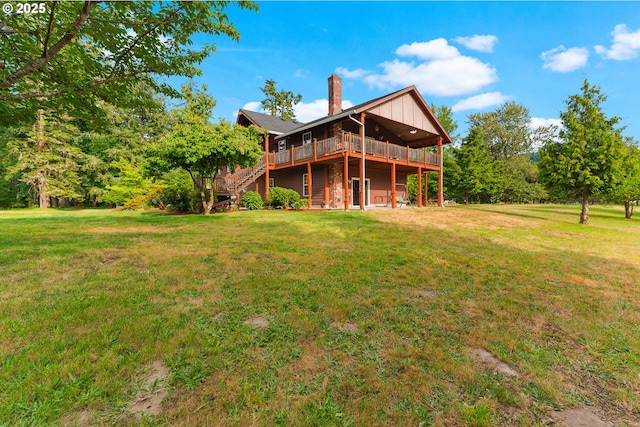 4311 NW 419th St, Woodland, WA 98674 - rear view of house with stairs, a chimney, a deck, and a lawn