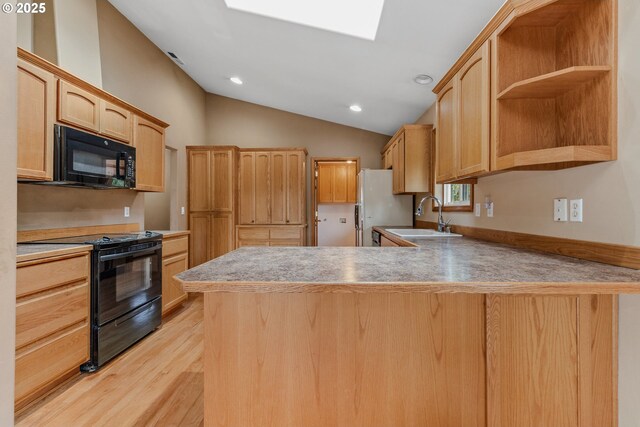 4311 NW 419th St, Woodland, WA 98674 - kitchen featuring black appliances, a peninsula, light wood-style flooring, light brown cabinetry, and vaulted ceiling