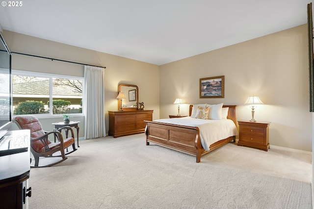 bedroom featuring light carpet