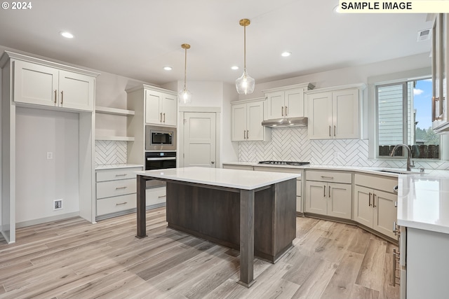 228 E 24th Ave, La Center, WA 98629 - kitchen featuring stainless steel microwave, oven, tasteful backsplash, open shelves, and light countertops