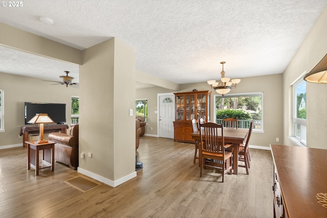 7375 SW 185th Ave, Beaverton, OR 97007 - dining space featuring a textured ceiling, light wood-style floors, a chandelier, and ceiling fan