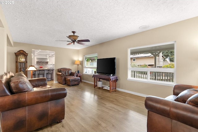 7375 SW 185th Ave, Beaverton, OR 97007 - living area with wood finished floors, a ceiling fan, and a textured ceiling