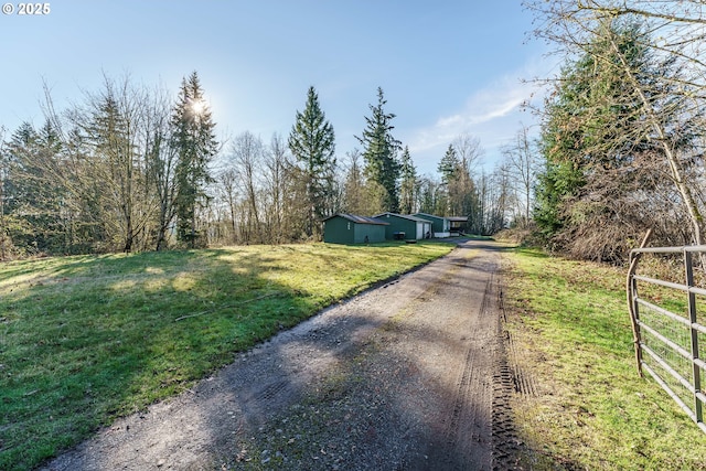 view of road featuring driveway and a gated entry