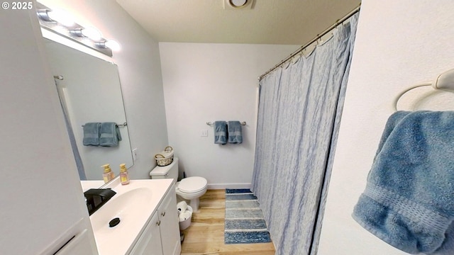 10690 SW Davies Rd Unit 53, Beaverton, OR 97008 - bathroom featuring wood finished floors, vanity, toilet, and a shower with curtain