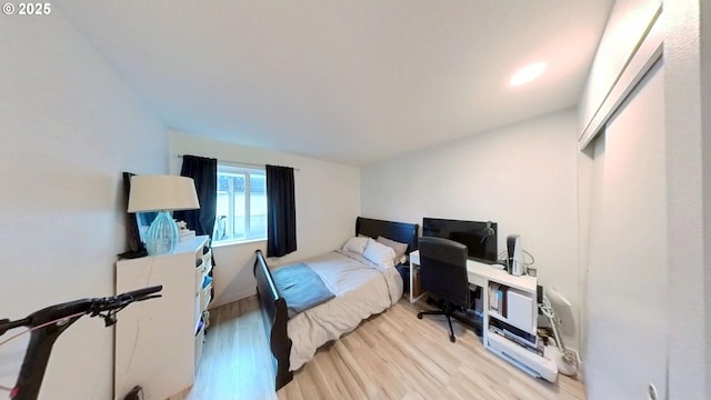 10690 SW Davies Rd Unit 53, Beaverton, OR 97008 - bedroom featuring light wood-style flooring, lofted ceiling, and an office area