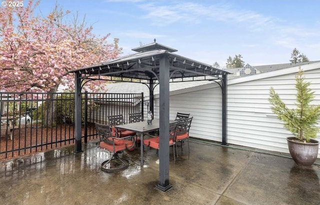 10690 SW Davies Rd Unit 53, Beaverton, OR 97008 - view of patio featuring a gazebo, fence, and outdoor dining area