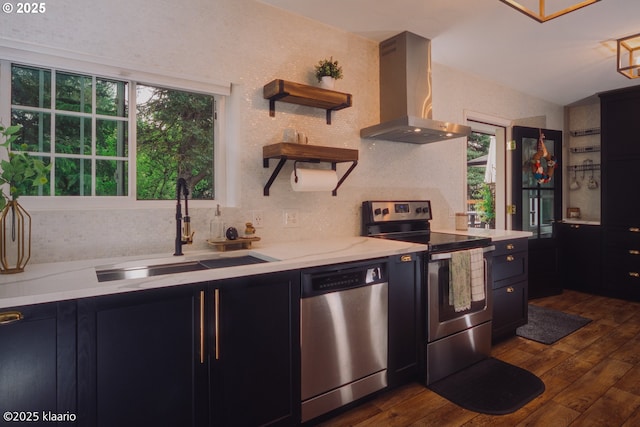 kitchen featuring open shelves, dark wood-style floors, extractor fan, a sink, and appliances with stainless steel finishes