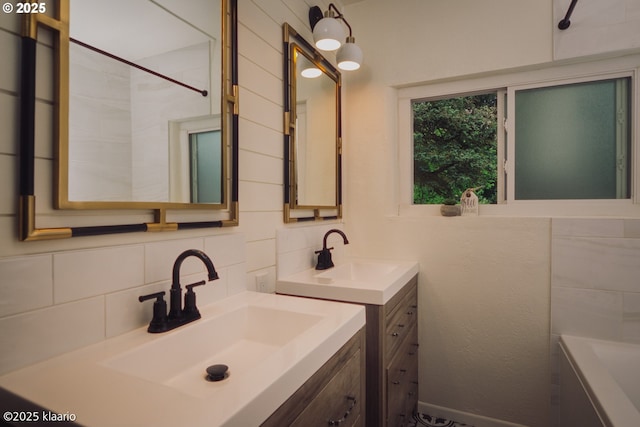 full bathroom with a sink, tasteful backsplash, a tub, and two vanities