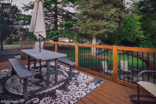 deck with a lawn and outdoor dining space