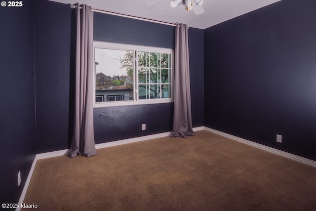 unfurnished room with baseboards, carpet flooring, and ceiling fan