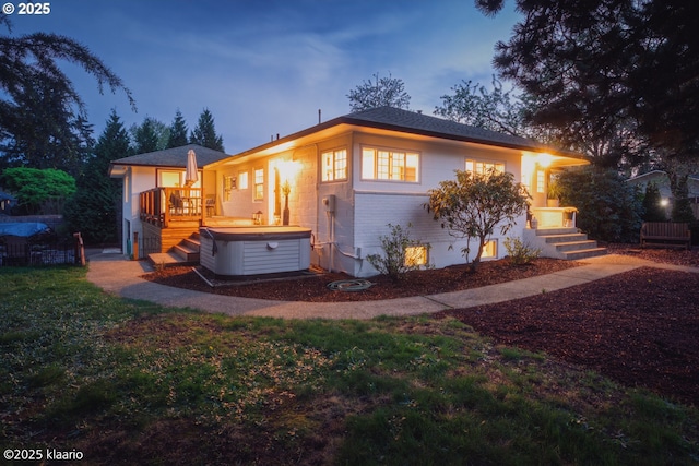 exterior space featuring a hot tub and a deck