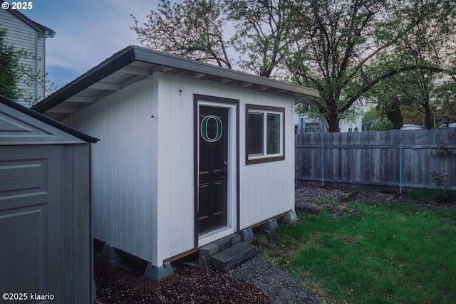 view of shed with fence