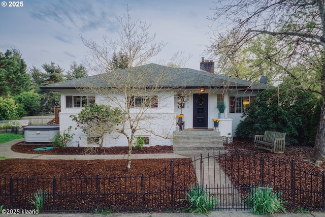 bungalow featuring a shingled roof, a fenced front yard, a gate, and a chimney