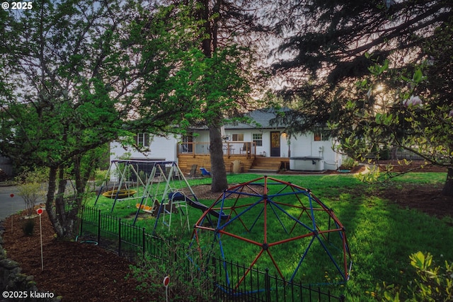 view of yard with fence, a deck, and cooling unit