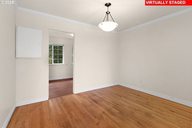 unfurnished room with hardwood / wood-style floors and crown molding