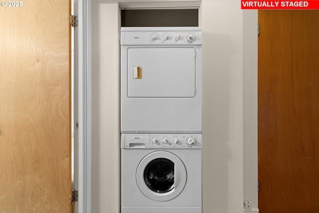 clothes washing area featuring stacked washer and dryer