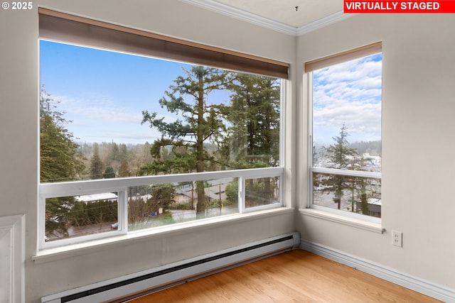 unfurnished sunroom with a baseboard heating unit and plenty of natural light