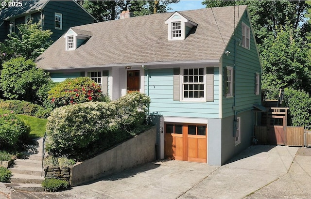 2645 SW Upper Drive Pl, Portland, OR 97201 - view of front facade with driveway, an attached garage, a chimney, stairs, and roof with shingles