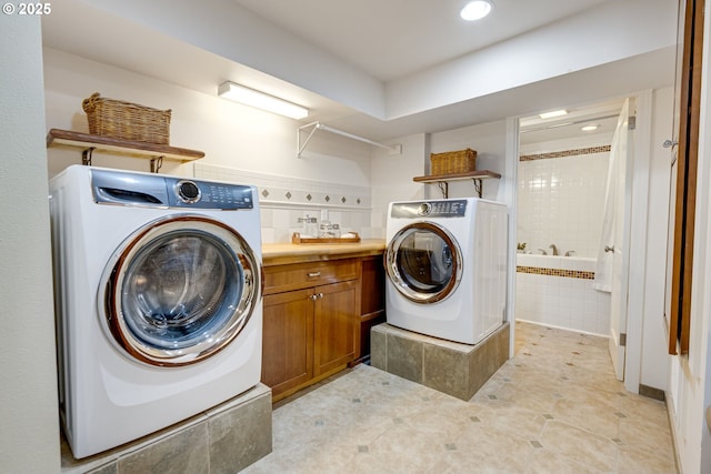 2645 SW Upper Drive Pl, Portland, OR 97201 - laundry area with washer / clothes dryer, recessed lighting, tile walls, light tile patterned flooring, and cabinet space
