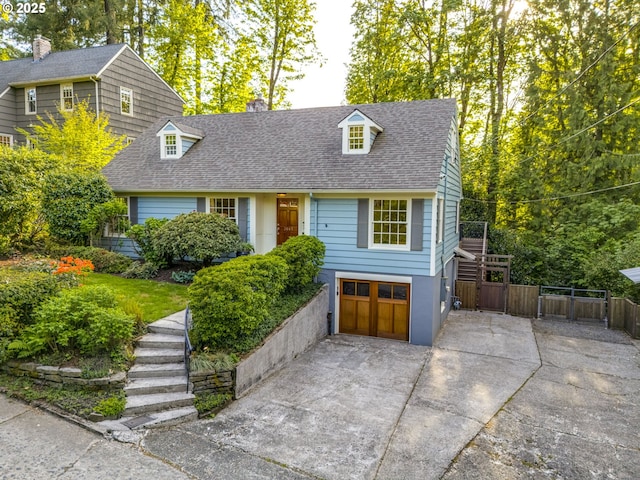 2645 SW Upper Drive Pl, Portland, OR 97201 - view of front of home featuring concrete driveway, roof with shingles, a garage, and a chimney