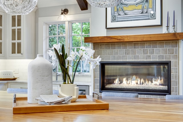 2645 SW Upper Drive Pl, Portland, OR 97201 - detailed view of a fireplace, backsplash, and wood finished floors