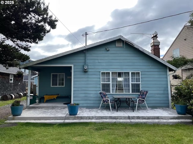 554 N Beacon St, Rockaway Beach, OR 97136 - back of house with a patio area and a chimney