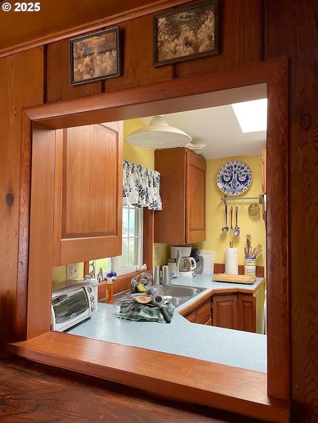 554 N Beacon St, Rockaway Beach, OR 97136 - kitchen featuring a skylight and light countertops