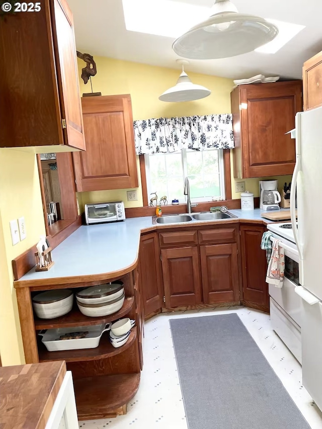 554 N Beacon St, Rockaway Beach, OR 97136 - kitchen with white appliances, brown cabinets, light countertops, and pendant lighting