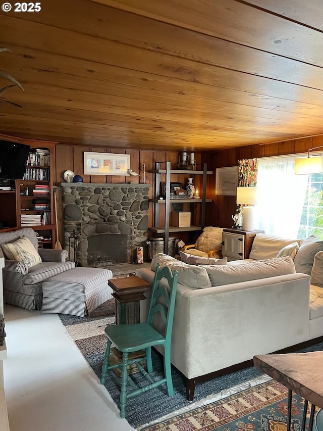 554 N Beacon St, Rockaway Beach, OR 97136 - living room featuring wooden ceiling, a fireplace, finished concrete flooring, and wooden walls