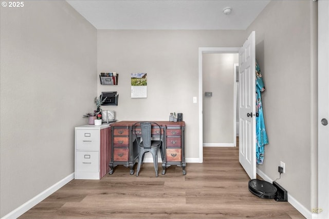 office space with baseboards and wood finished floors