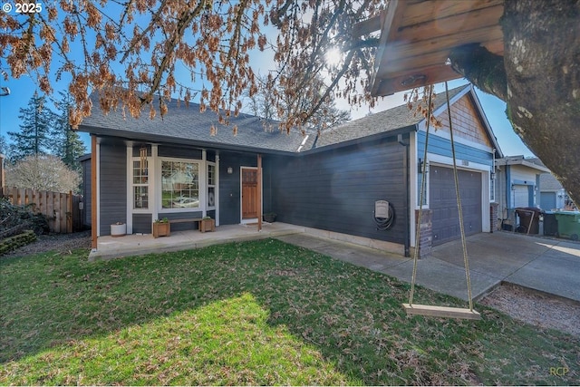 single story home featuring concrete driveway, a front lawn, an attached garage, and fence