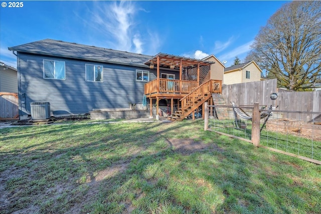 rear view of house featuring cooling unit, fence, a lawn, stairway, and a wooden deck