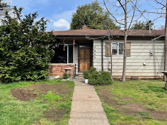 7955 SE Center St, Portland, OR 97206 - view of front facade with crawl space and a chimney