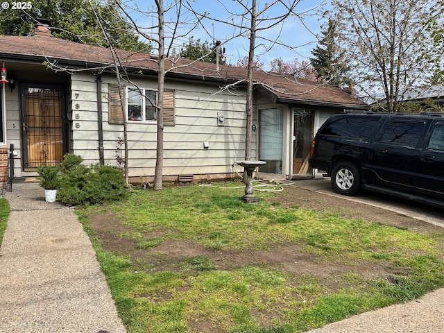 7955 SE Center St, Portland, OR 97206 - view of side of property with crawl space and a chimney
