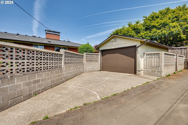 607 W 35th St, Vancouver, WA 98660 - view of patio / terrace featuring an outdoor structure, driveway, and a detached garage